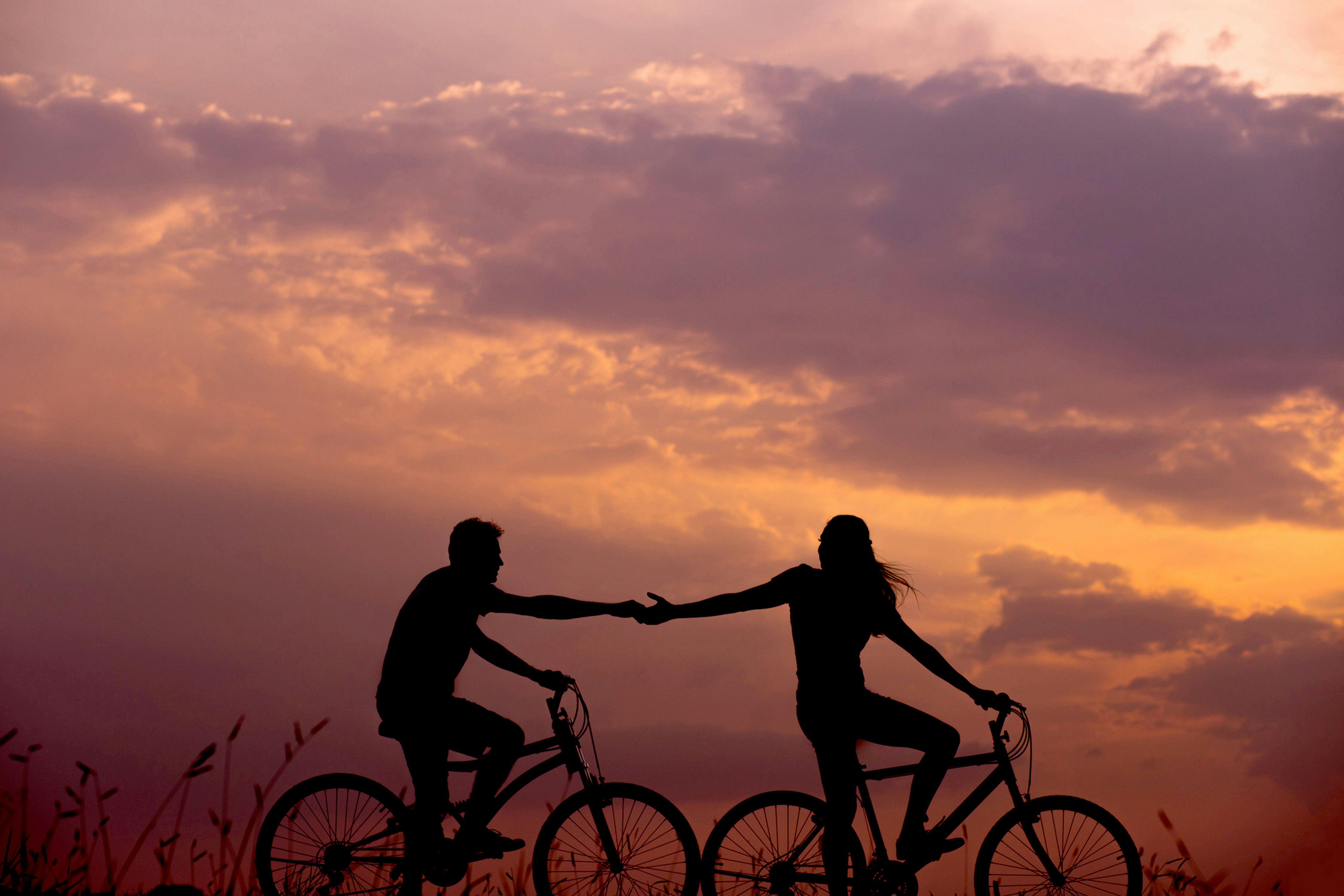 A couple holding hands while walking together, symbolizing growth and connection in their relationship